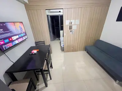 a room with a couch and a table and a tv at shore 2 tower 3 4 floor in Manila
