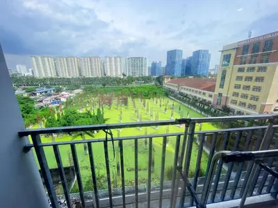 a balcony with a view of a park and buildings at shore 2 tower 3 4 floor in Manila