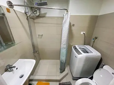 a bathroom with a toilet and a sink and a shower at shore 2 tower 3 4 floor in Manila