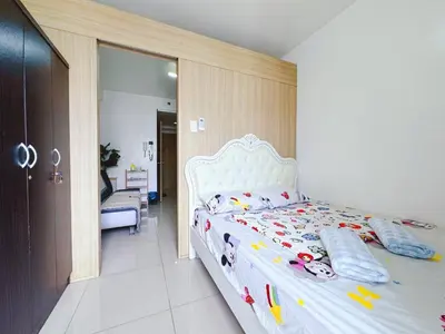 a bedroom with a white bed with toys on it at Shore 1 tower c1 17floor near moa facing swimming pool in Manila