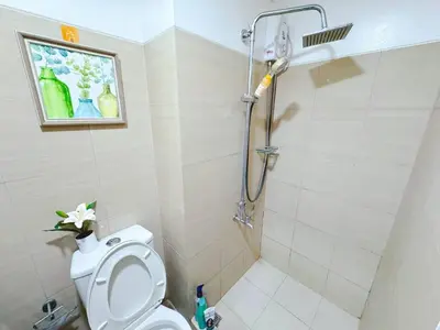 a bathroom with a shower with a toilet and a sink at Shore 1 tower c1 17floor near moa facing swimming pool in Manila