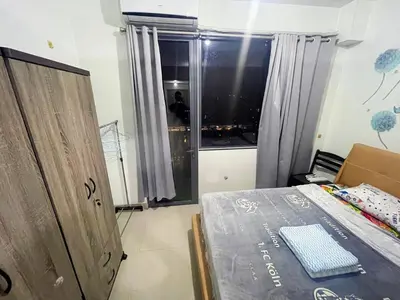 a bedroom with a bed and a window with a view at shore 2 tower 1 19 floor in Manila