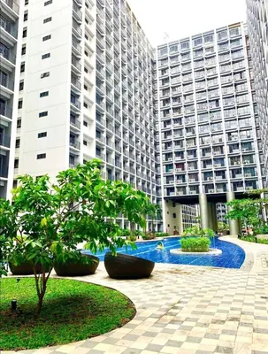 a large building with tall buildings in the background at shore 2 tower 1 19 floor in Manila