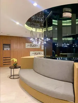 a lobby with a couch in front of a bar at shore 2 tower 1 19 floor in Manila
