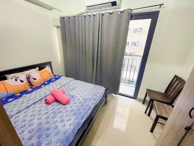 a bedroom with a bed with two red slippers on it at shore 2 tower 2 4 floor in Manila