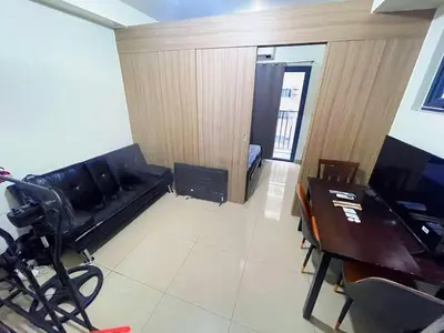 a room with a couch and a table and a desk at shore 2 tower 2 4 floor in Manila