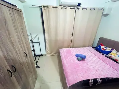 a bedroom with a pink bed with a stuffed animal on it at shore 2 tower 2 3 floor in Manila
