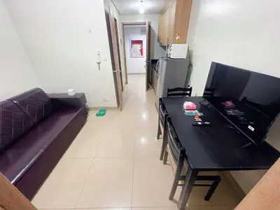 a living room with a black table and a couch at shore 2 tower 2 3 floor in Manila