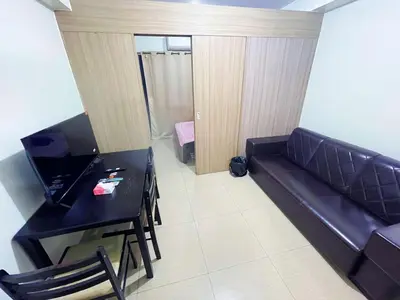 a living room with a couch and a table at shore 2 tower 2 3 floor in Manila