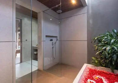 a bathroom with a shower with a glass door at warda private villa in Pasong Bayog