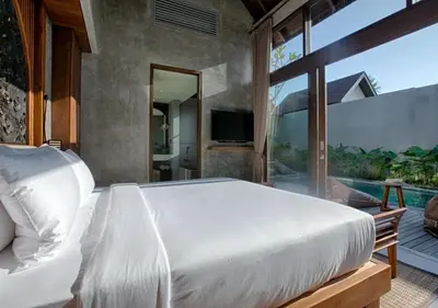 a bedroom with a white bed and a large window at warda private villa in Pasong Bayog