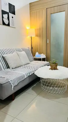 a bedroom with a large bed and a table at Direct Access to pool Bedroom in Manila