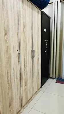 a pair of wooden doors in a room with a doorway at Direct Access to pool Bedroom in Manila