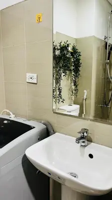 a bathroom with a white sink and a mirror at Direct Access to pool Bedroom in Manila