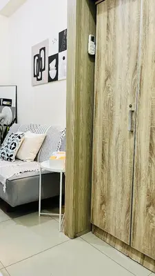 a bedroom with a bed and a wooden door at Direct Access to pool Bedroom in Manila