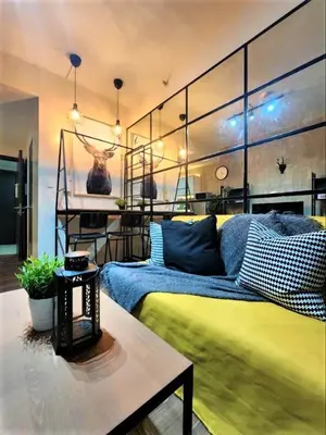 a living room with a bed and a table at Air Residences with 500Mbps Wifi in Manila