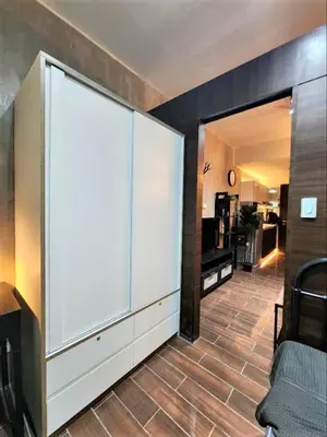 a room with a large white door and a kitchen at Air Residences with 500Mbps Wifi in Manila