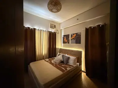 a bedroom with a bed with a light on it at Casa Josefina in Manila