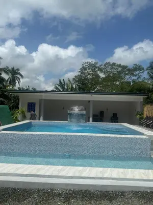 a swimming pool with a fountain in front of a house at Amadeo Verde in Amadeo