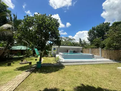 a backyard with a swimming pool and a fence at Amadeo Verde in Amadeo