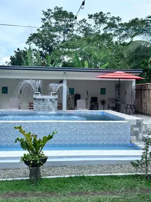 a swimming pool in front of a house at Amadeo Verde in Amadeo