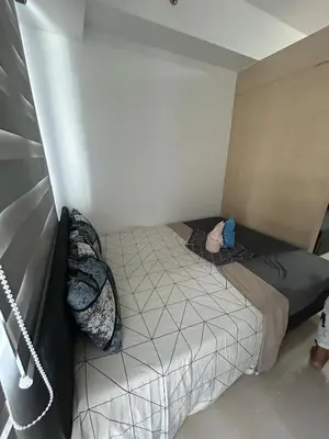 a small bed in a small room with at Staycation at MALL OF ASIA -by Tess Ualat in Manila