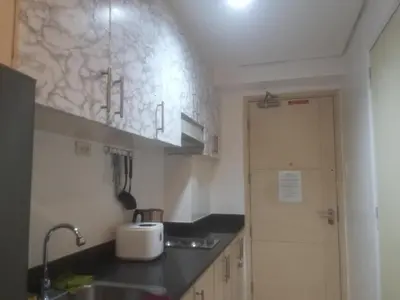 a kitchen with a sink and a counter top at Staycation at MALL OF ASIA -by Tess Ualat in Manila