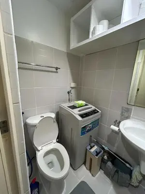 a small bathroom with a toilet and a sink at Staycation at MALL OF ASIA -by Tess Ualat in Manila