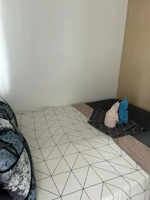 a room with a bed with a tiled floor at Staycation at MALL OF ASIA -by Tess Ualat in Manila
