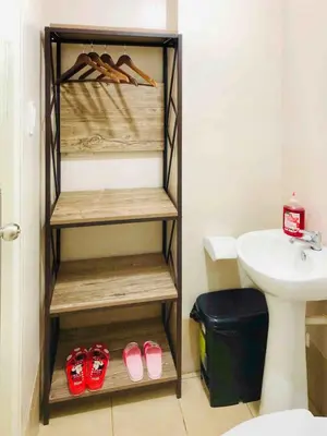 a bathroom with a shelf with shoes and a sink at Cozy Comfy stay, tiny suite in Nuvali, SouthForbes in Silang