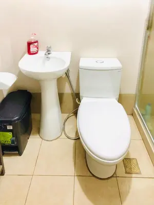 a bathroom with a toilet and a sink at Cozy Comfy stay, tiny suite in Nuvali, SouthForbes in Silang