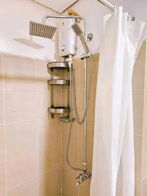 a shower in a bathroom with a shower curtain at Sabrina Staycaytion in Manila