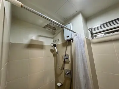 a bathroom with a shower with a shower curtain at Shore 3 Residences Room 1659 infront of SM MOA in Manila