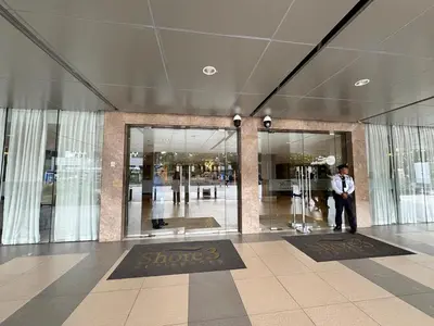a man standing in the entrance to a building at Shore 3 Residences Room 1659 infront of SM MOA in Manila