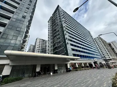 a large building in a city with tall buildings at Shore 3 Residences Room 1659 infront of SM MOA in Manila