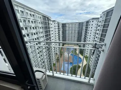 a balcony with a view of a large building at Shore 3 Residences Room 1659 infront of SM MOA in Manila
