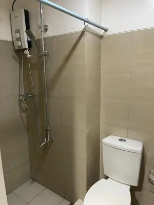 a bathroom with a shower and a toilet in it at Bay stays at shore residence in Manila