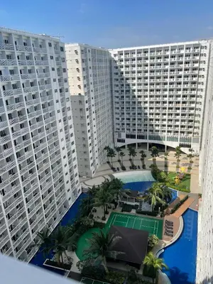 an aerial view of a large apartment building with a pool at Bay stays at shore residence in Manila