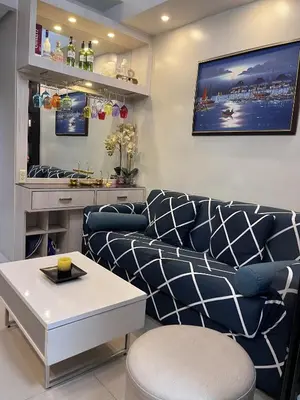 a living room with a couch and a table at EaseStay by Bren in Shell Residences MOA in Manila