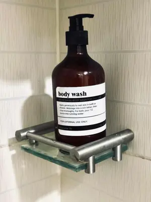 a bottle of body wash on a shelf in a bathroom at Exquisite 2 Bedroom Suite in Manila