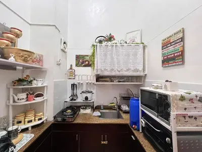 a small kitchen with a sink and a microwave at Pahingahan in Cainta