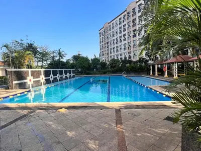 a large swimming pool in front of a building at Pahingahan in Cainta