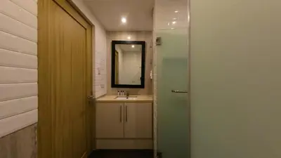 a bathroom with a sink and a mirror at Full-Serviced Residential Apartment in Blue Sapphire, BGC in Manila