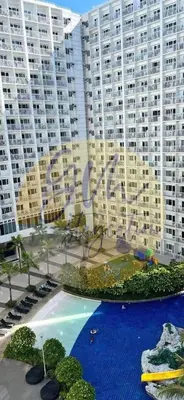 a view of a large apartment building with a swimming pool at 10th Floor Facing Amenity in Manila