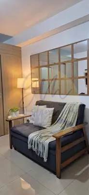 a bedroom with a bed with a wooden frame at 10th Floor Facing Amenity in Manila