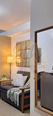 a bedroom with a bed with a mirror and a tv at 10th Floor Facing Amenity in Manila