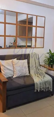 a couch with a blanket on it in a room at 10th Floor Facing Amenity in Manila