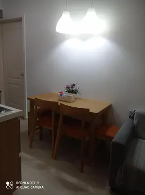 a small table with a potted plant on top of it at Azure Condo by arlene in Manila