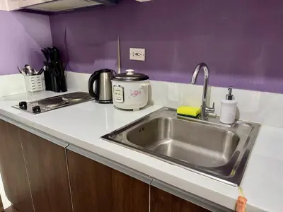 a kitchen counter with a sink in a kitchen at City Bliss Chill Vibes Makati 5338 Netflix Swim Gym Park Superfast Net in Manila