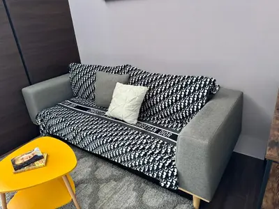 a couch with a pillow on it in a room at City Bliss Chill Vibes Makati 5338 Netflix Swim Gym Park Superfast Net in Manila